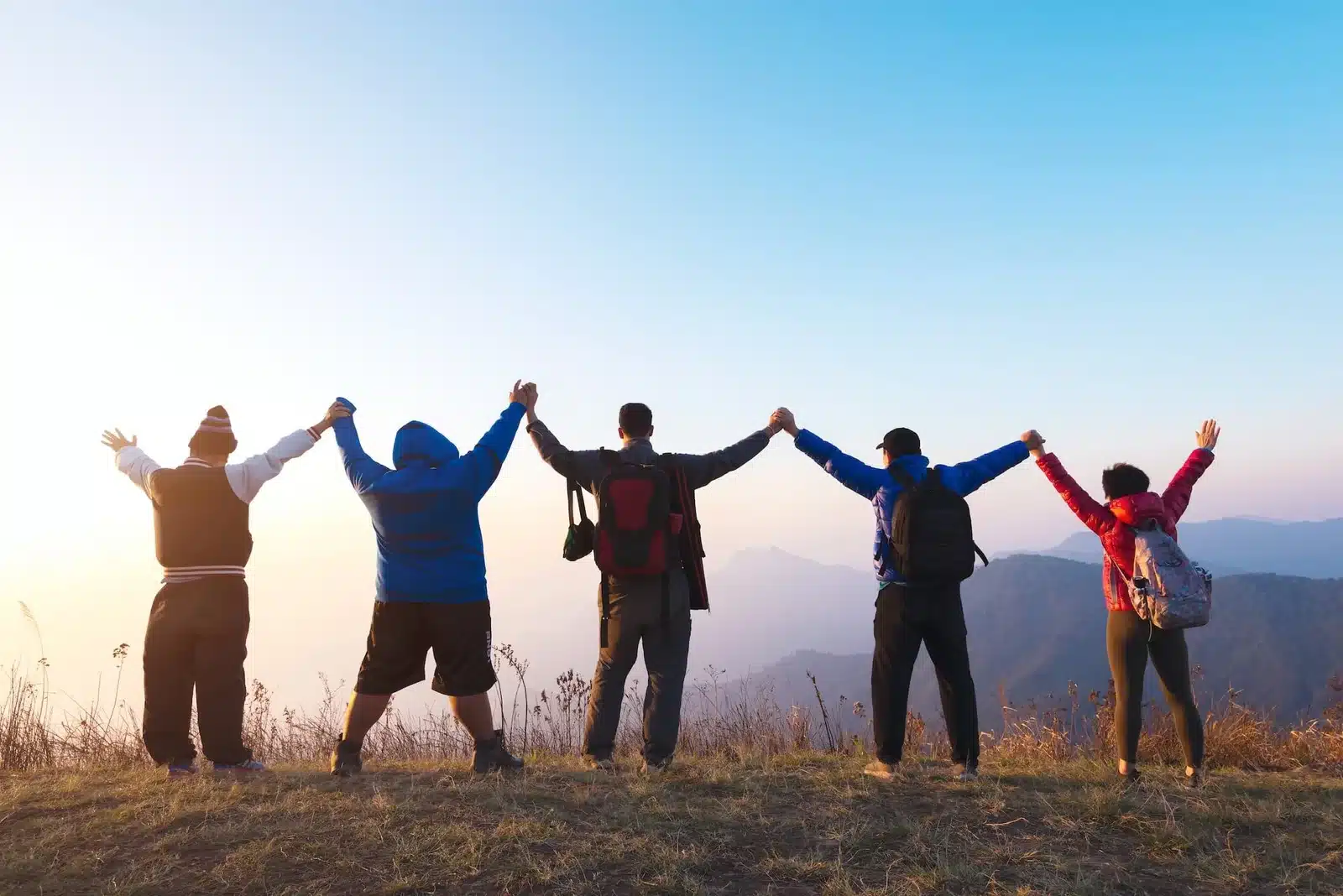 Group of friends holding hands outdoors