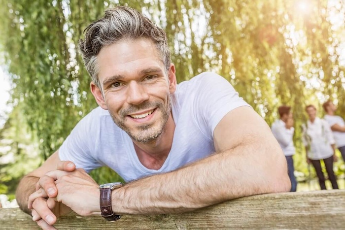 IntoAction Man Outdoors smiling at cameraman 1