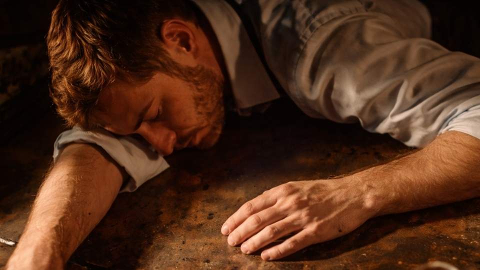 a man passed out from alcohol during one of the stages of addiction.