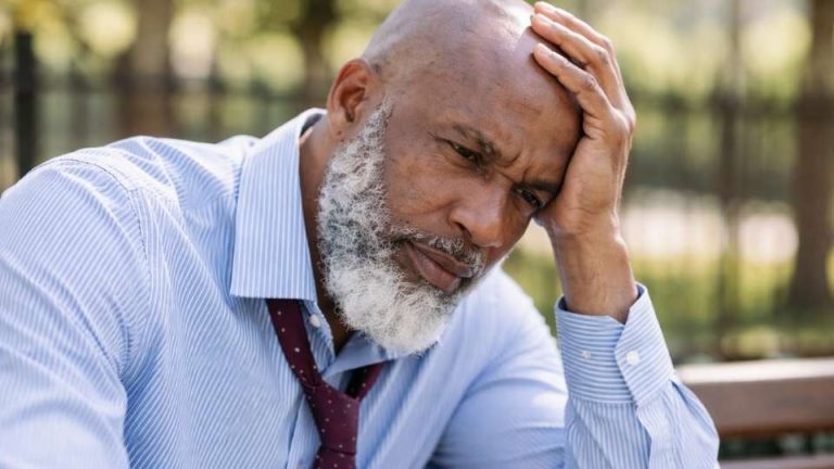 a man wonders How to Quit Drinking Alcohol while sitting outside