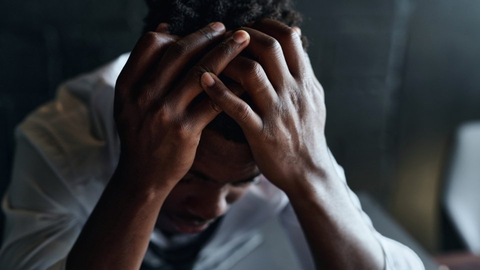 Does Drinking Alcohol Cause Anxiety hero image of a man feeling down.