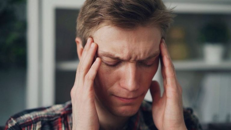 Ativan Withdrawal Symptoms A Complete Timeline hero image of a man with a headache.