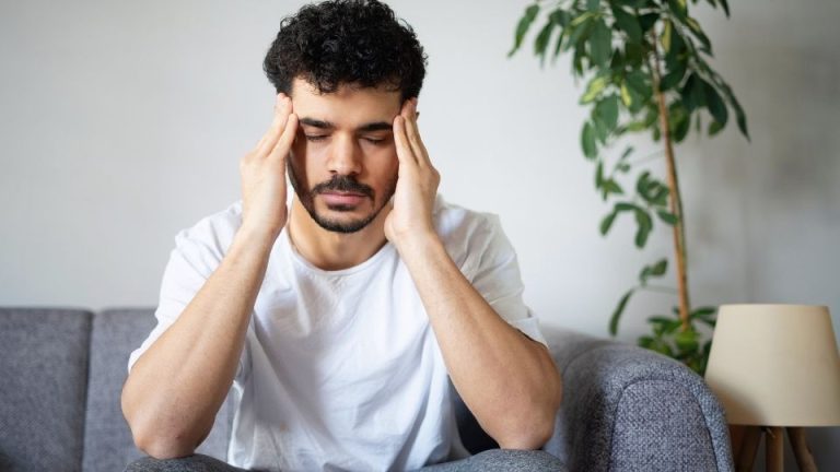 concerta vs ritalin hero image of a man holding his head after getting cravings.