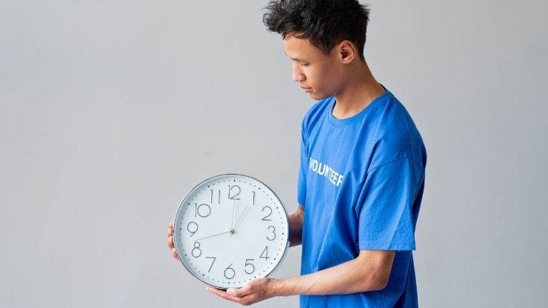 how long does adderall last hero image of a man looking at a clock.