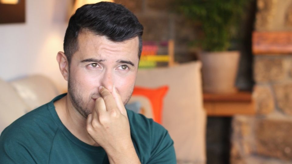 a man holding his nose who comes through with cocaine use.